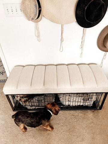 You can place dog crates under an upholstered bench to make them more aesthetically pleasing but still functional. 