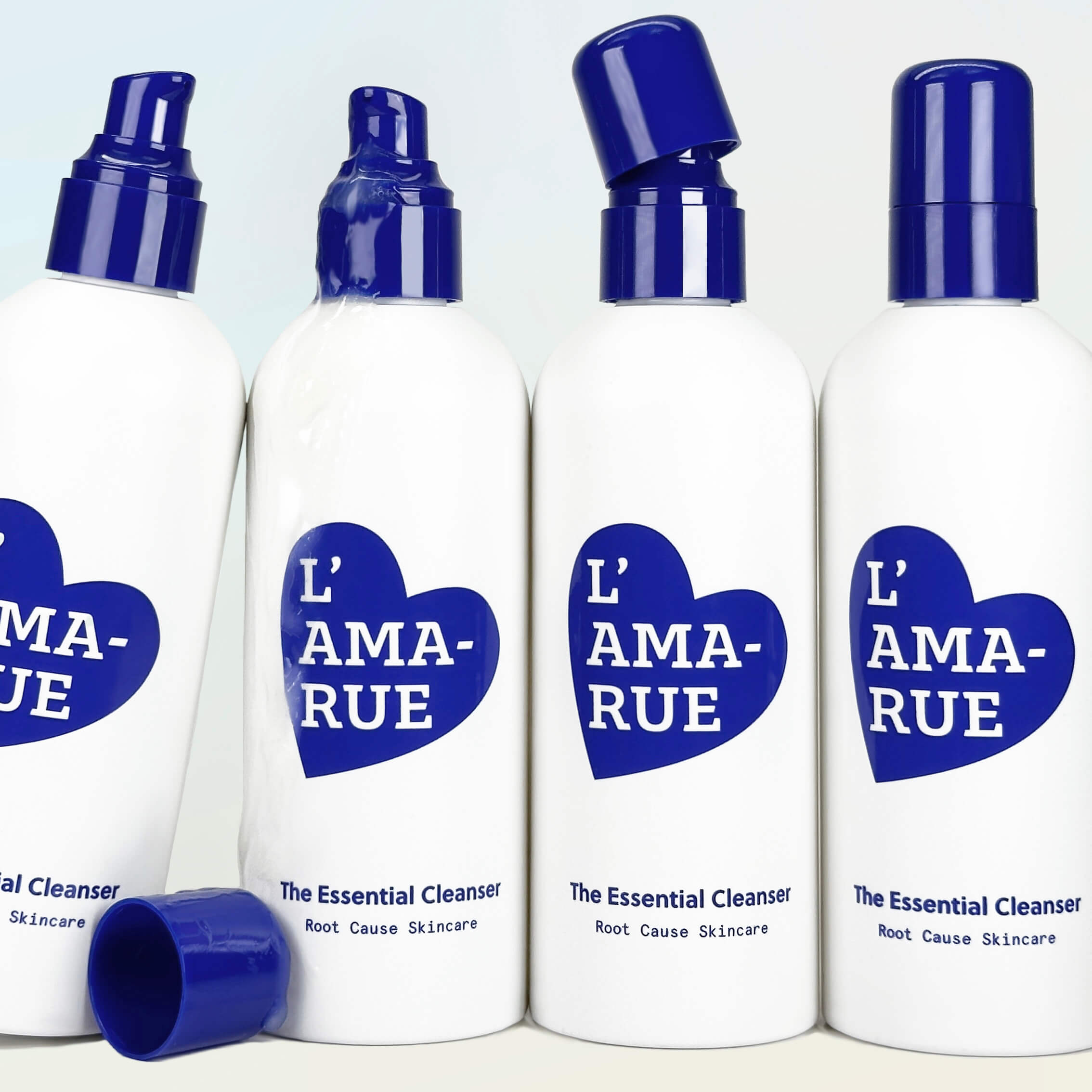 Four white and blue skincare product bottles against a light blue background.