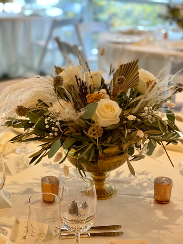 Dried flowers and rose centerpiece in gold bowl for wedding reception