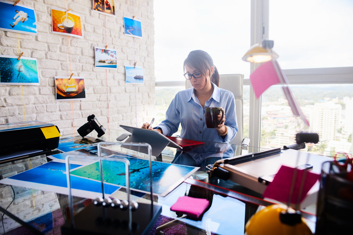 Woman at office printing quality color images with an inkjet printer