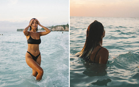 Free Photo | Fasionable model posing on rock beach, on sunset, near sea,  ocean. sexy woman wearing black bikini, swimsuit with hight waist,  cardigan, cape with ornaments.