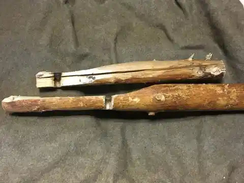 Two carved sticks with burn marks.