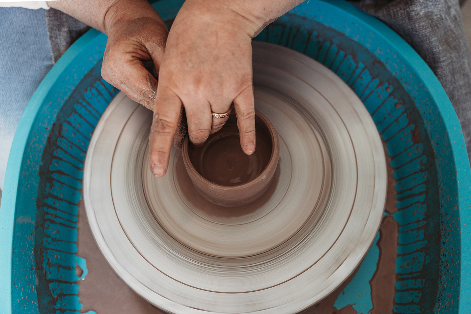 Throwing clay on the wheel by Australian ceramic artist and potter Elkie Fairbrother exclusive mugs and cups for Palinopsia Ceramics 