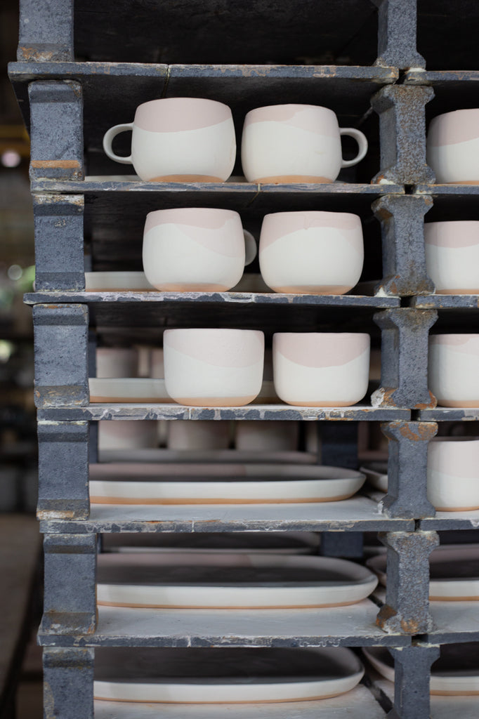 Handmade ceramic dinner sets pre-firing in the kiln at Palinopsia Ceramics 