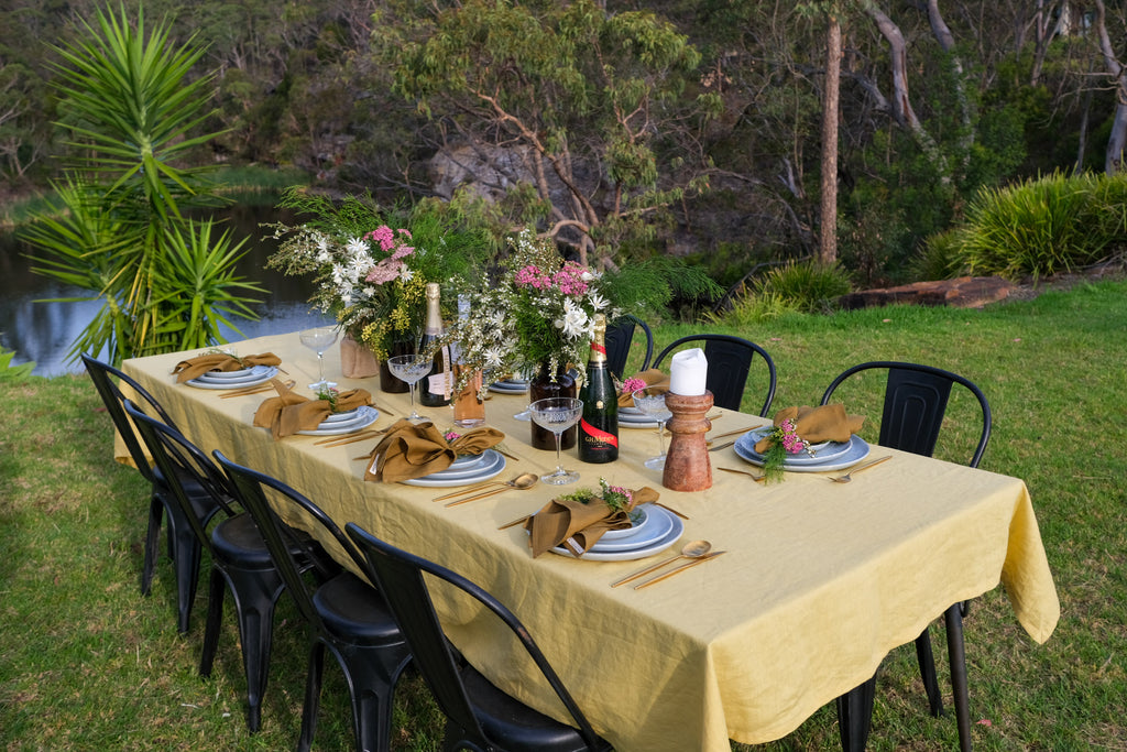 Bright outdoor summer table in Sydney Australia with handmade blue dinnerware