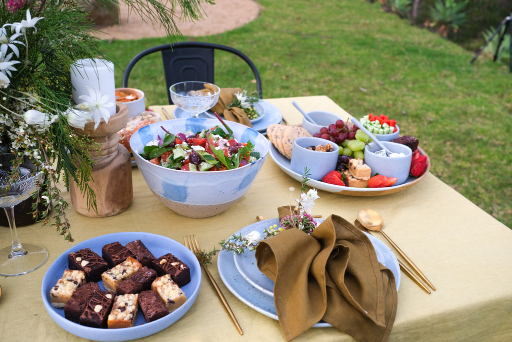 Bright Summer Table setting by Palinopsia Ceramics and Soul Origin Catering Salads, brownies and grazing boards