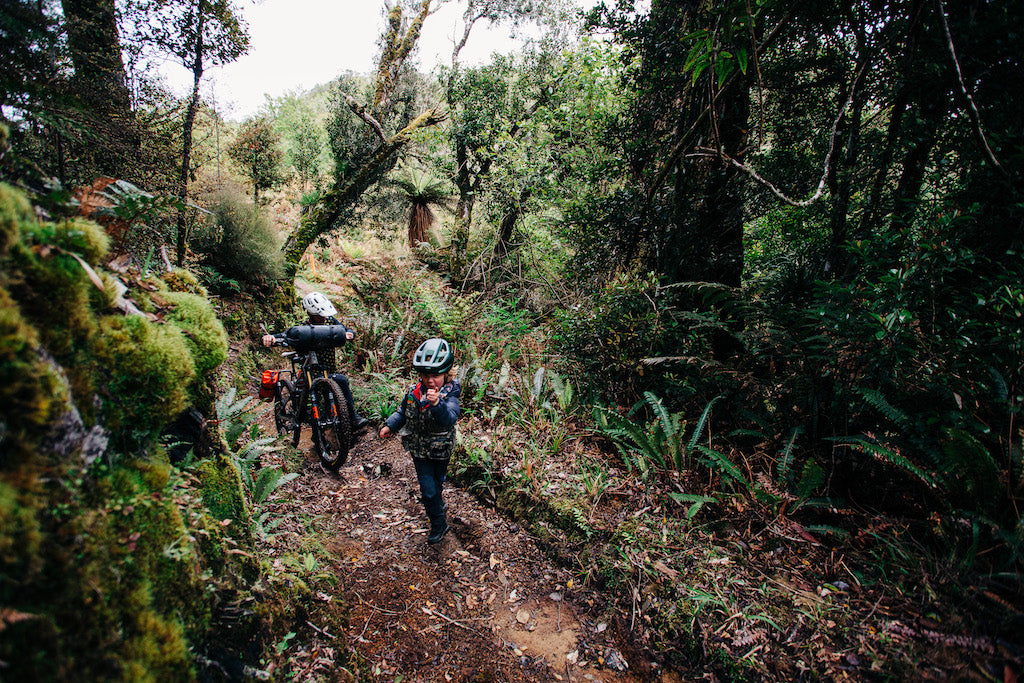 Kid and Mountain bike on the trail in forest