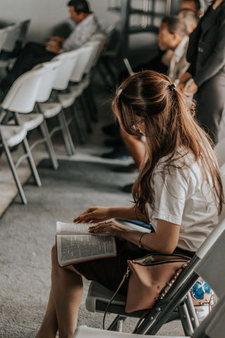 Woman reading the Bible in church