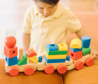 Child playing with Melissa & Doug Stacking Train. Available from tenlittle.com