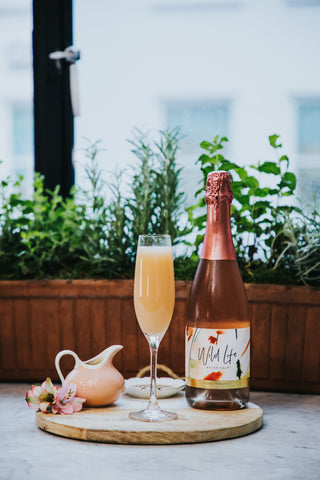 Peach Me I'm Dreaming non-alcoholic cocktail, Wild Life Botanicals Blush andingredients on platter
