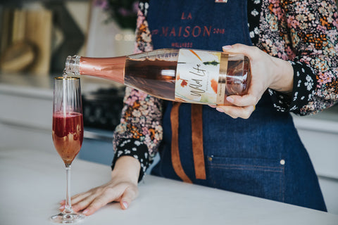 Amour non-alcoholic cocktail, pouring Wild Life Botanicals Blush in the flute 