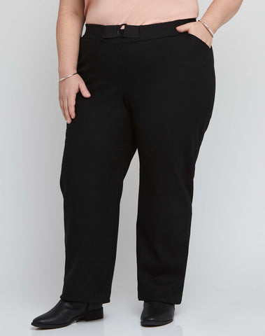 Front view of size 18 model wearing black stretch plus size work pants with an adjustable waist.