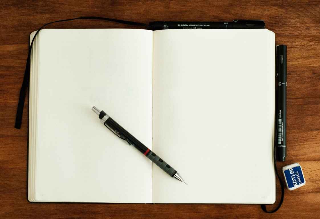 Open notebook on a table. Photo by Mike Tinnion.