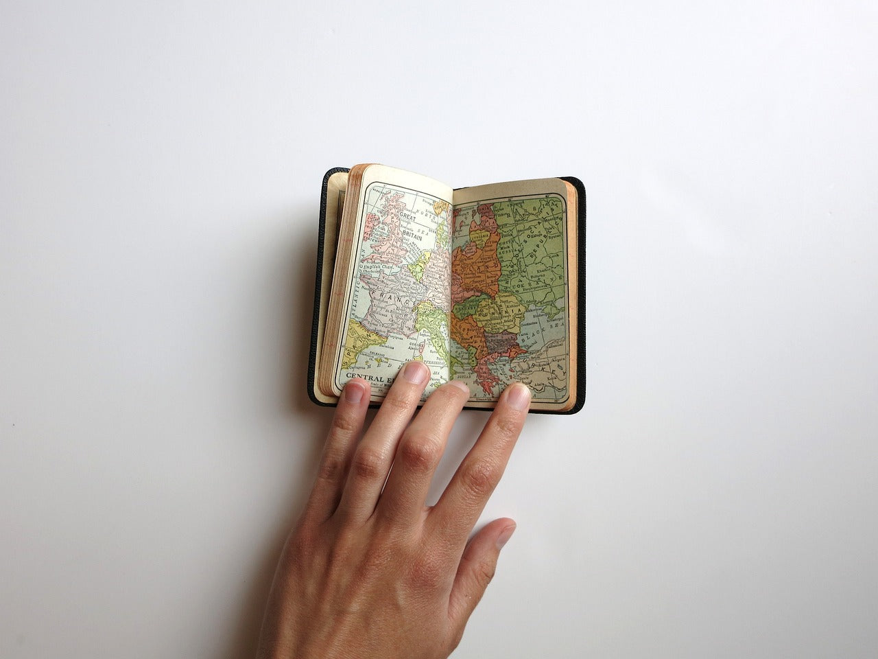 A small book open to a page with a map of the world.
