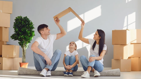 a man and woman with their child planning to have their own house