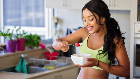 a woman eating healthy foods