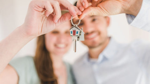 a couple holding a key
