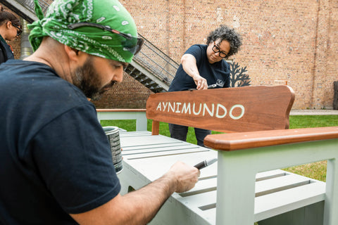 A woodworker is touching up a DuroGrit application at the Rubio Monocoat Atelier.