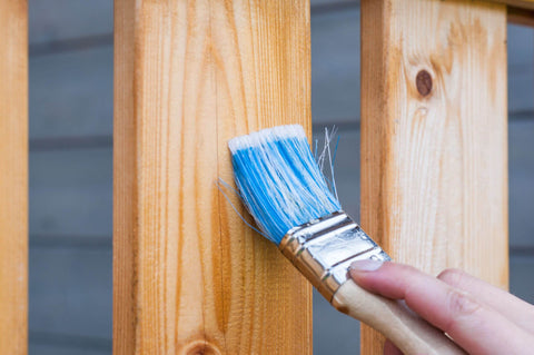 Applying wood stain to exterior vertical boards using a paint brush