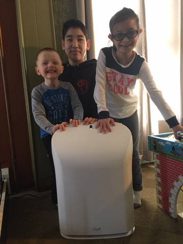 BioGS 2.0 air purifier in front of three children