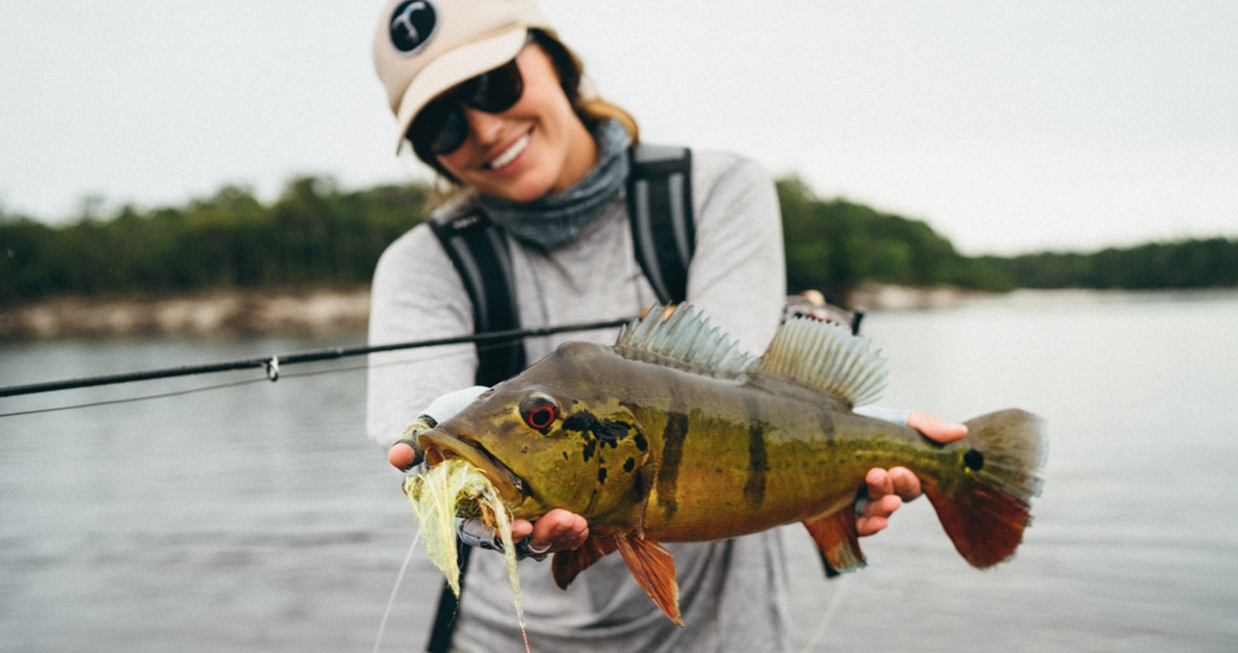 Maddie holding up tropical fish and smiling