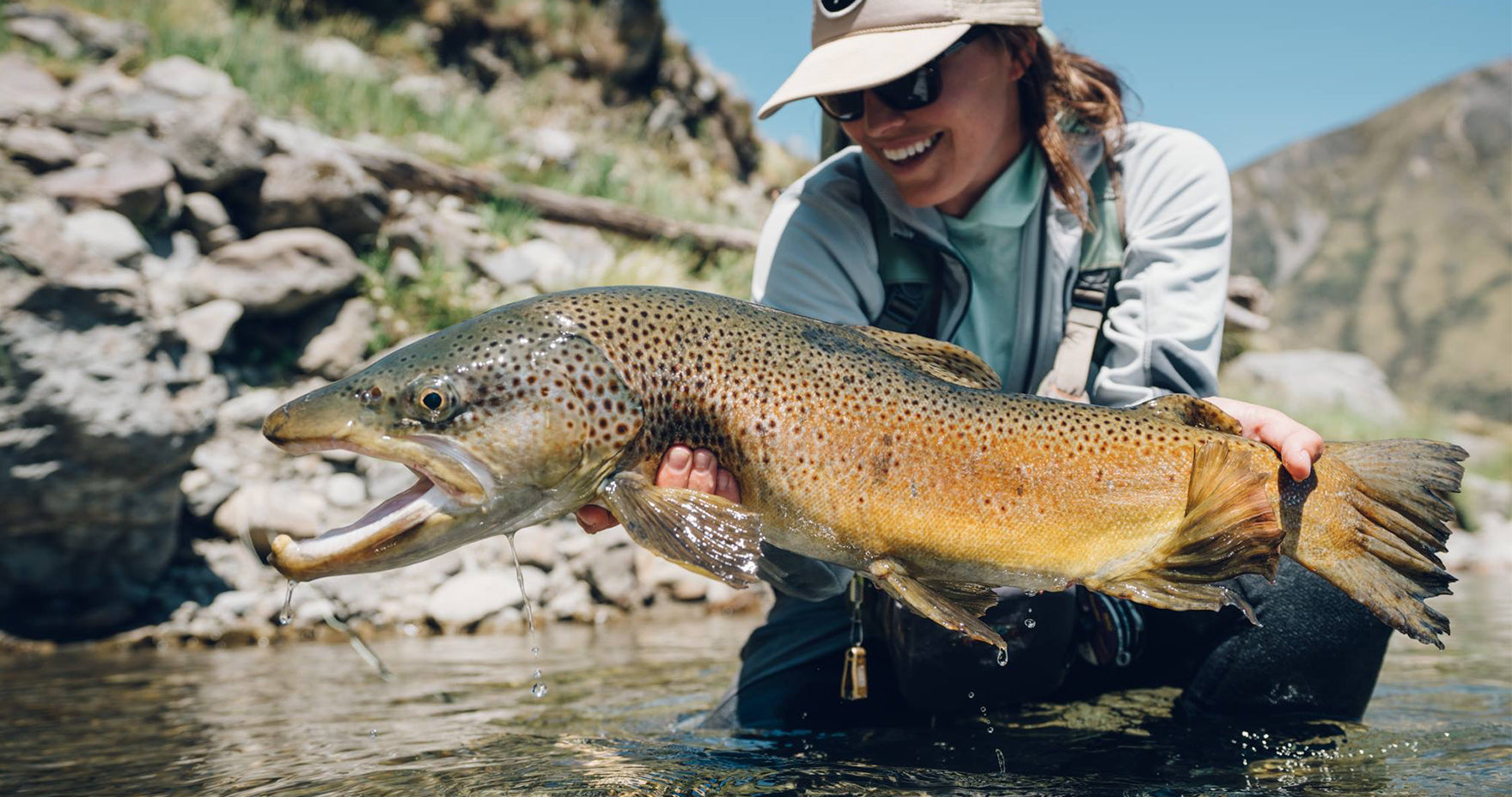 Maddie holding large fish in water