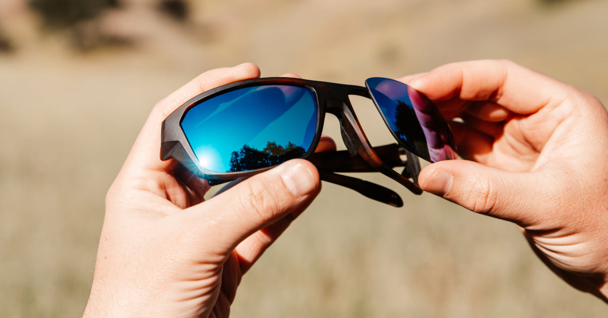 Image of a person changing out their sunglass lenses.