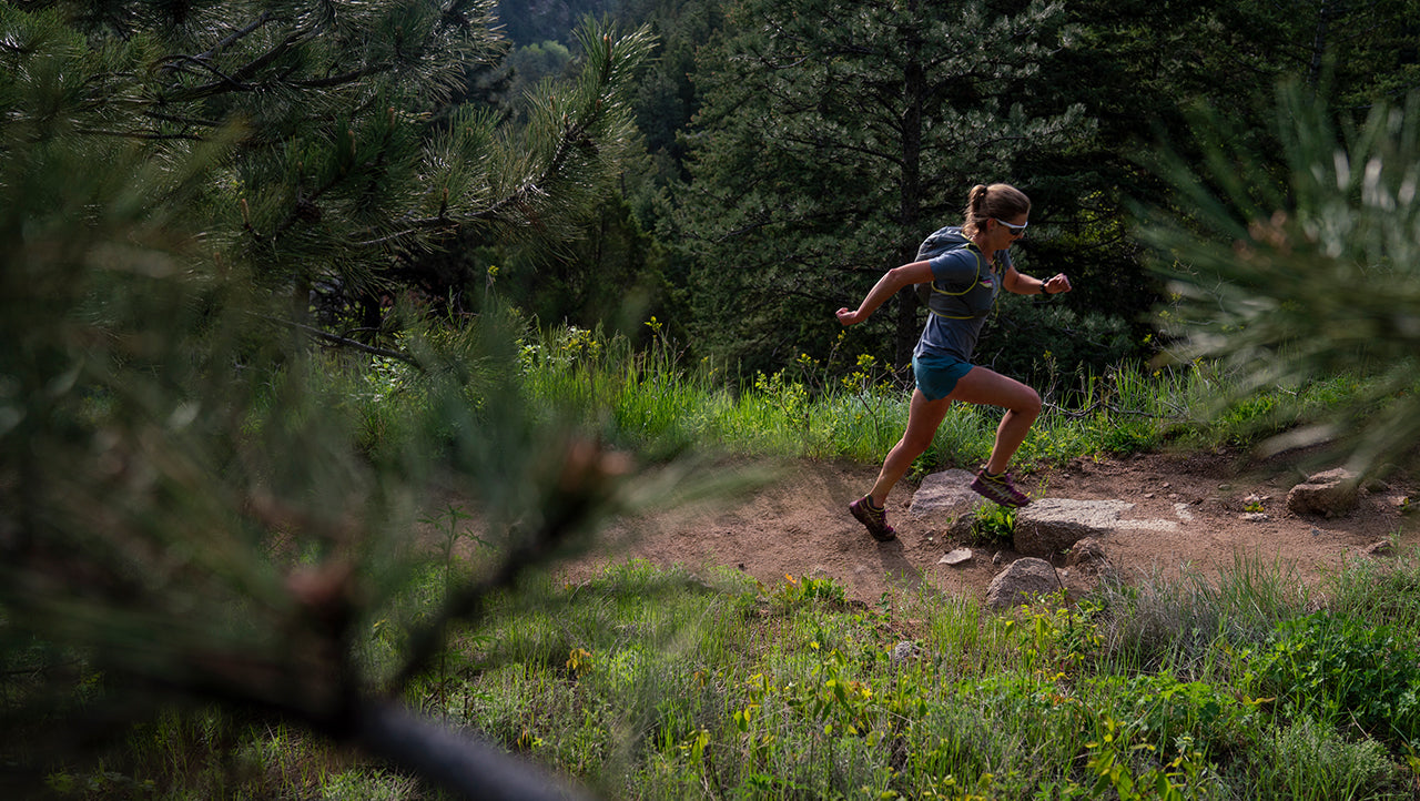 Clare Gallagher running through the forest