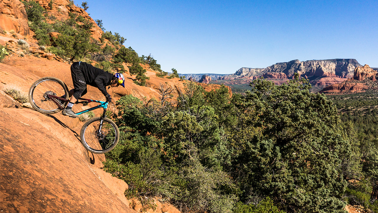 Carson Storch Riding down steep red rock