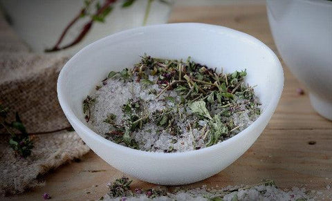 A bowl of Mugwort and salt. Keep reading to learn about Mugwort magical properties.