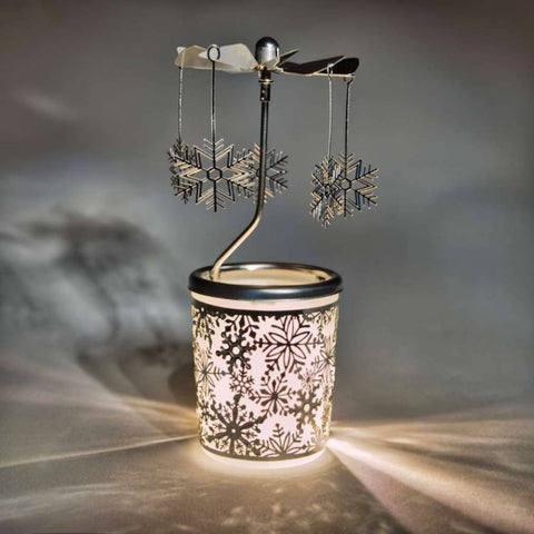 Silver carousel with a tealight burning inside it so the snowflake carousel twirls