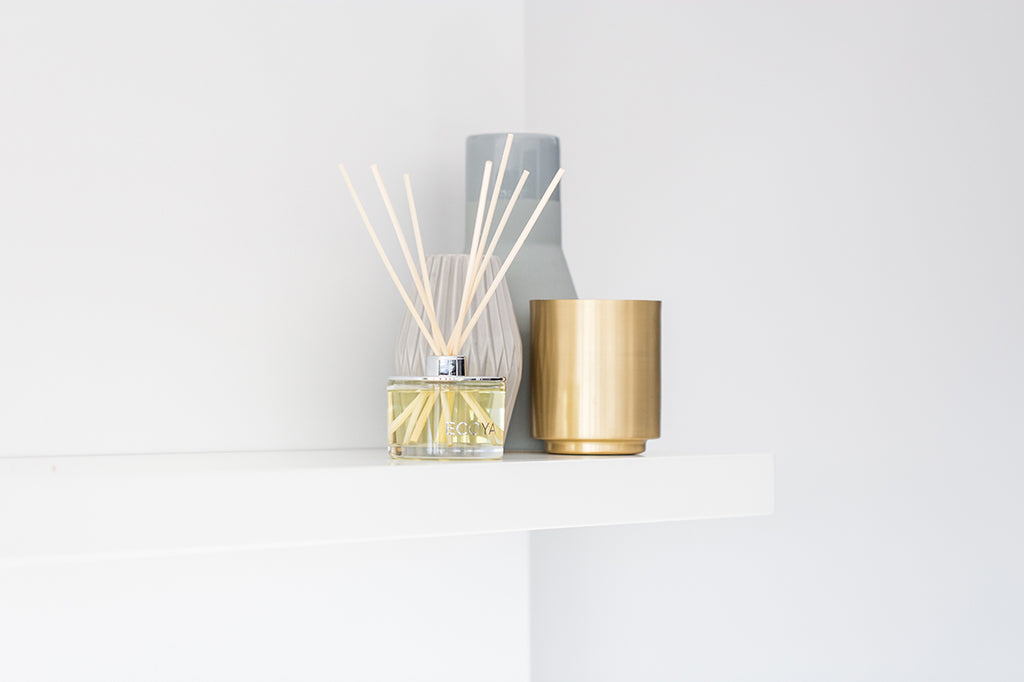 a fragrance diffuser on a white shelf