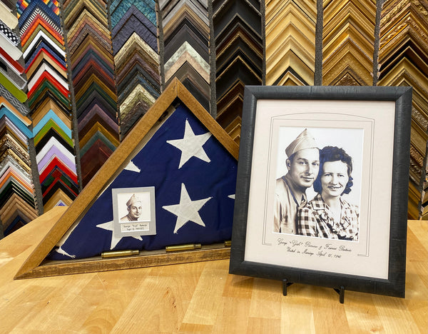 Framed military flag from WWII veteran and a framed photograph of him and his wife honoring their marriage.