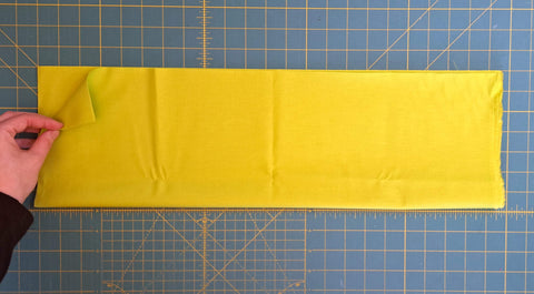 A photo of a width of fabric piece folded.