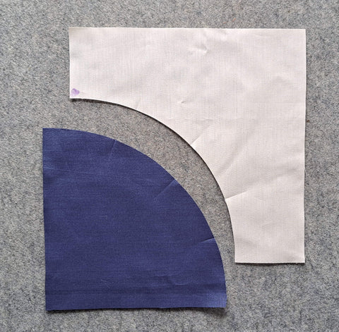 One arch piece and one curved pieced both folded with three creases.