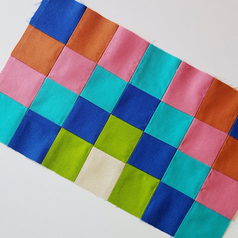 photo of strip pieced quilt block on a white background
