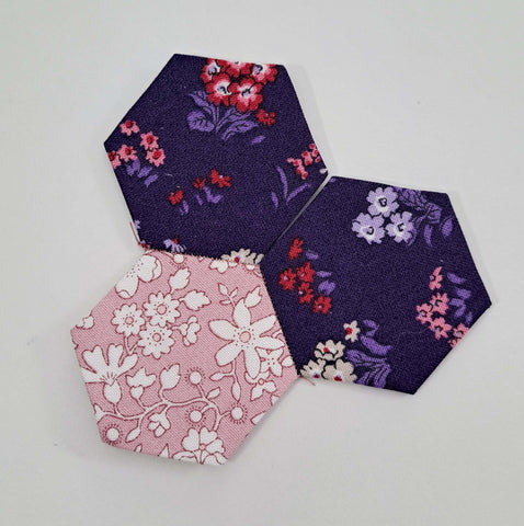 Photo of three hexagons nearly sewn together
