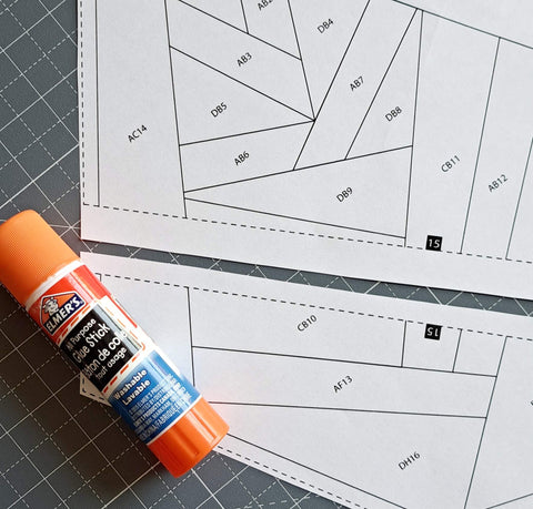 glue stick being used to glue two foundation paper piecing templates together