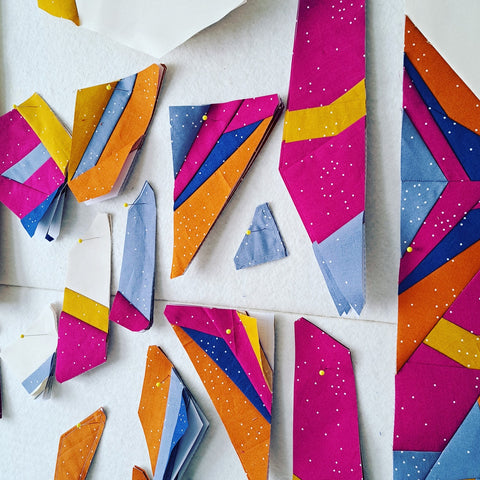 nesting phoenix foundation paper pieces pinned to quilt design wall
