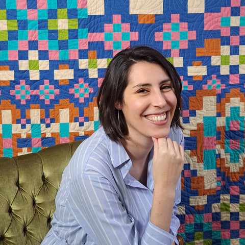 photo of cristina de miranda in front of fado road quilt