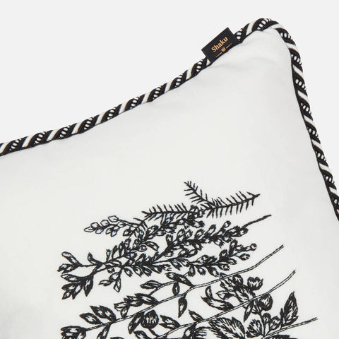 Details of cord piping on white embroidered cushion