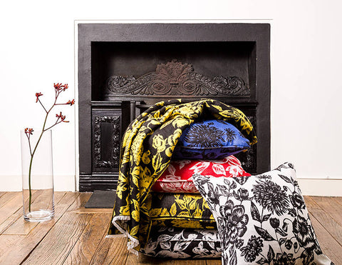 Stack of Floral Cushions in front of fireplace