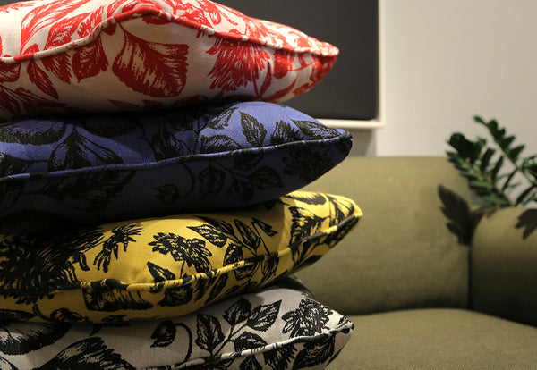 Colourful stack of Shaku upcycled silk cushion collection