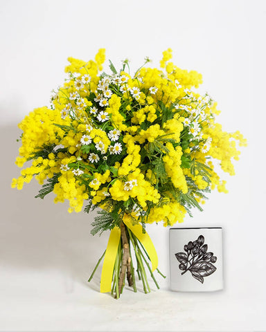 Yellow flowers and small jasmine candle