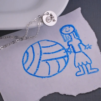 Child’s artwork necklace. Kid’s drawing of girl and a ball engraved on stainless steel pendant on sterling silver filled chain.