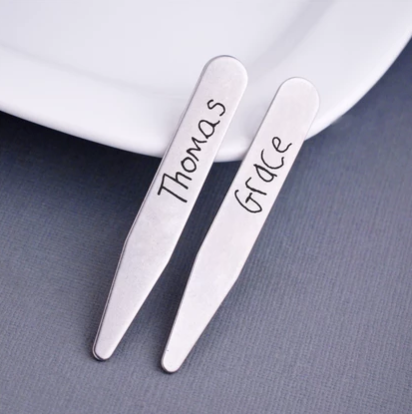 Custom handwriting collar stays engraved with children’s signatures “Thomas” and “Grace”, in stainless steel.
