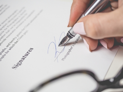 woman signing signature on form (image credit: Canva)