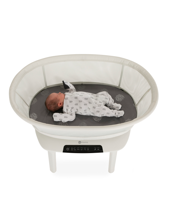 baby in a 4moms bassinet