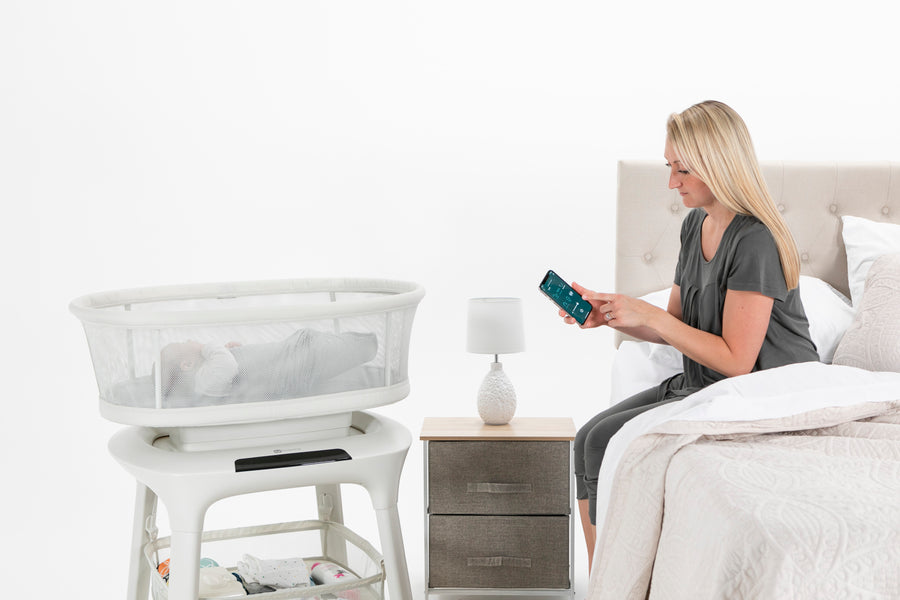 woman next to 4moms bassinet with baby