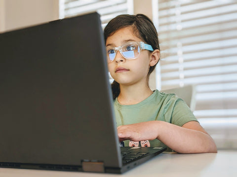 Girl browses computer with blue blocking snappies glasses